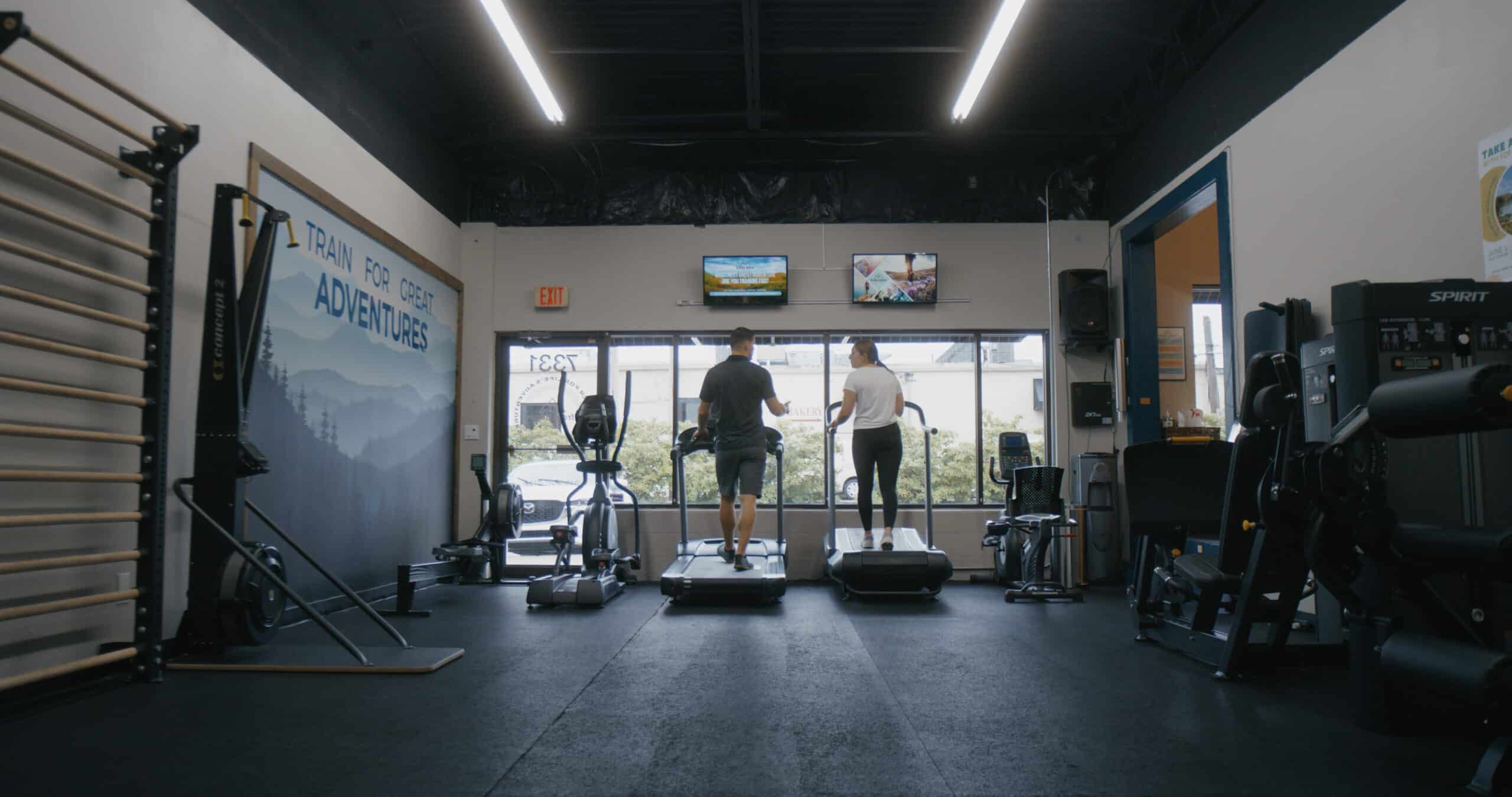 man and woman on treadmill